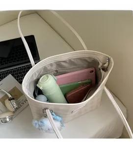 Interior view of spacious plaid tote bag showing large capacity for laptop and daily essentials