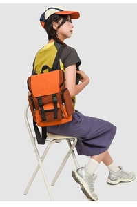 Detail view of contrast color outdoor backpack featuring buckle closure and side pockets