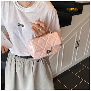 Close-up of pink quilted crossbody bag with silver twist-lock and chain handle