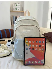 Blue star pattern backpack next to an iPad showing a practical size comparison view