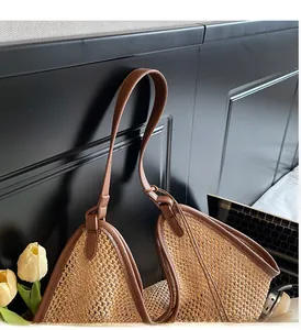 Close-up of durable straw tote bag woven texture with premium brown leather handle