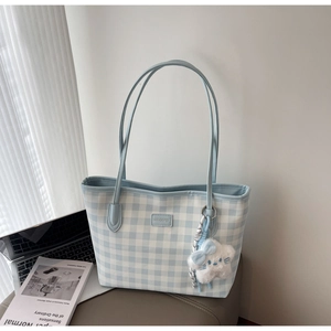 Detail of blue checkerboard tote bag with MEIGEREI leather label and plush star charm