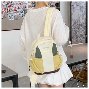 Detail of color-block mini backpack with drawstring pockets and adjustable straps