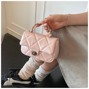 Detail view of pink quilted mini handbag with silver chain handle and swivel lock clasp