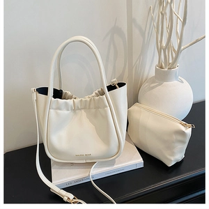 Detail of off-white pleated bucket bag set with inner pouch and adjustable strap