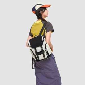 Detail of color-block backpack with buckle closure and side pockets in outdoor style