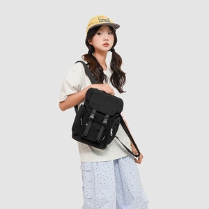 Detail of black tactical nylon backpack with adjustable buckle straps and flap closure