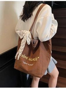 Brown canvas tote bag with Crème Glacée print and white lace bow accessory