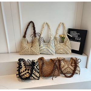 Detail of handcrafted crochet beach bags with chic scrunchie handles and boho textures