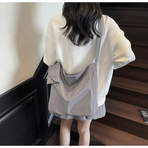 Detailed back view of a light purple oversized nylon tote bag with matching coin pouch