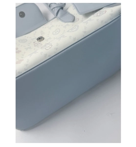 Detail of light blue leather stitching with cartoon bunny patterns and magnetic buckle closure