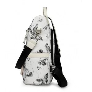 Detail of butterfly print backpack showing side profile, metal hardware, and tassel