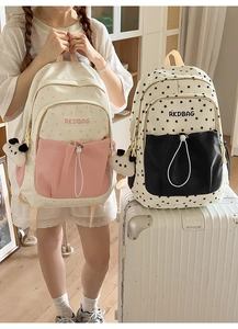 Detail of Korean style school backpack with star patterns and cute panda keychain accessory