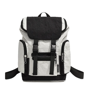 Detail of color-block backpack showing buckle closure and nylon texture by KLEIMAN