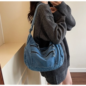 Detail view of denim shoulder bag featuring multi-pocket design and retro blue fabric