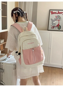 Close-up of pink star pattern backpack with a cute dog pendant in a cozy home setting
