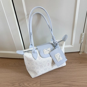 Close-up of light blue floral tote bag with cute cat prints and matching coin purse