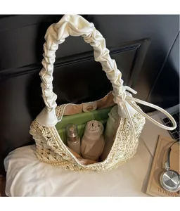 Detail view of woven straw tote showing large interior space with magnetic metal buckle