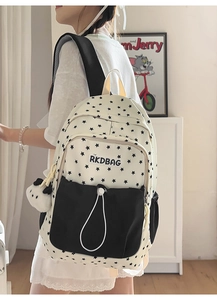 Detail of star pattern canvas backpack with panda pendant and drawstring front pocket