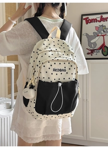 Detail view of cream canvas backpack with star print and black drawstring pocket