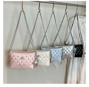 Detail of star-shaped charms and quilted texture on colorful chain shoulder bags