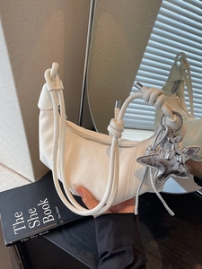White crescent moon bag with puffy shoulder strap and silver star charm detail