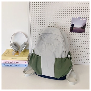 Detail of tricolor lightweight nylon backpack with RGYBAO logo and drawstring side pockets