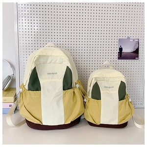 Detail view of color-block college backpack showing adjustable drawstring side pockets