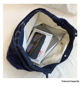 Internal view of blue denim tote bag showing spacious capacity and inner pocket