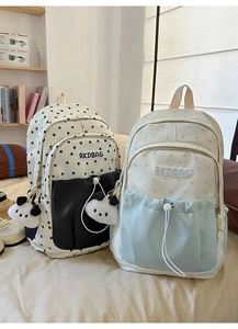 Detail of star pattern backpacks in black and light blue with panda plush charms