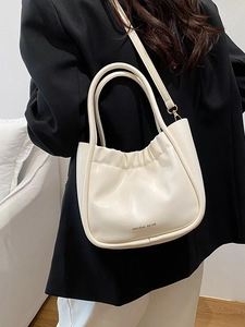 Chic beige pleated bucket bag with top handle and crossbody strap for modern women