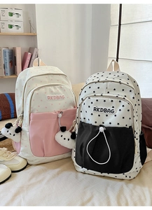 Detail of Korean style school backpacks with star patterns and cute panda plush charms