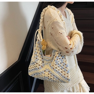Detailed close-up of handmade crochet tote bag with ruffles and diamond knit pattern
