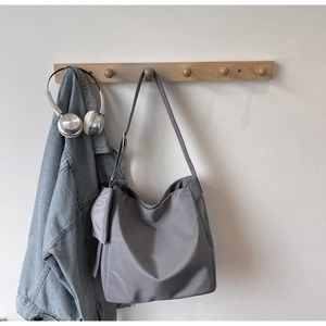 Detail of grey slouchy tote bag with matching zipper pouch and large capacity interior