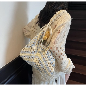 Detailed close-up of handmade crochet bag with geometric hollow patterns and chic bow strap