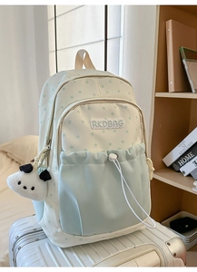 Detail of canvas backpack with star print, RKDBAG embroidery and panda plush charm