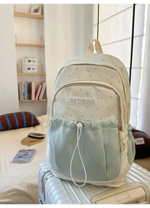 Detail of college style backpack with star pattern and RKDBAG embroidery on front pocket