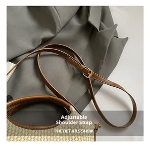 Detail of adjustable leather shoulder strap and woven texture on casual tote bag