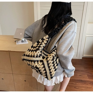 Detail of bohemian crochet knit bag with black leather shoulder strap for summer beach style