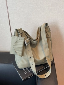 Chic olive green nylon tote bag with wide eyelet strap and matching mini pouch