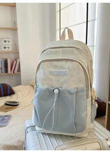 Detail of canvas backpack featuring star patterns and RKDBAG embroidery on front pocket