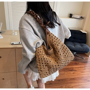 Macro detail of the woven hollow diamond pattern on this large brown shoulder bag