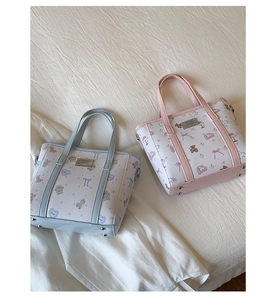 Close-up of cute cartoon bear prints and metal protective feet on bucket tote bags