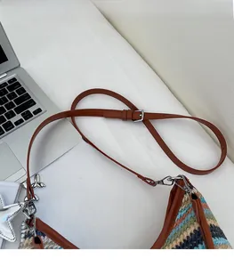 Détail de la bandoulière réglable en cuir et texture tissée rayée colorée du sac de plage
