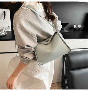 Close-up of light blue lychee pattern leather shoulder bag with silver metal swivel lock