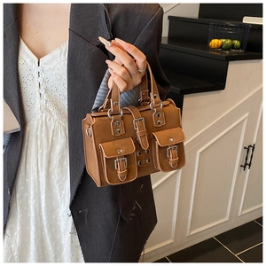 Brown vintage multi-pocket handbag with silver buckles shown in a lifestyle setting