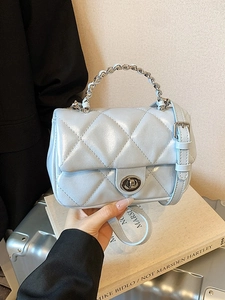 Sky blue quilted crossbody bag with metal chain handle and turn-lock closure