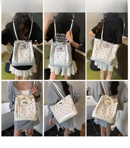 Detail of floral tote bag showing bow patterns and adjustable straps for multiple ways to wear