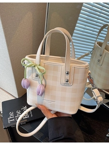 Fashionable cream checkered crossbody bucket bag with tulip charm and adjustable strap