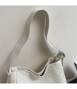 Detailed close-up of textured waffle pattern and durable shoulder strap on white tote bag